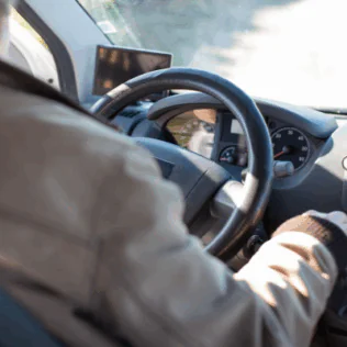 Person in White Long Sleeve Shirt Driving Car