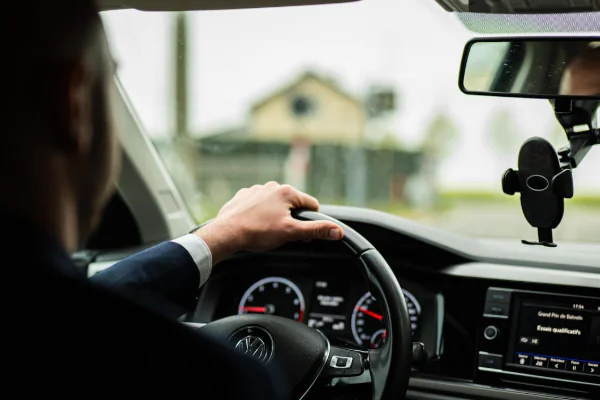 Businessman Driving Car on Rainy Day