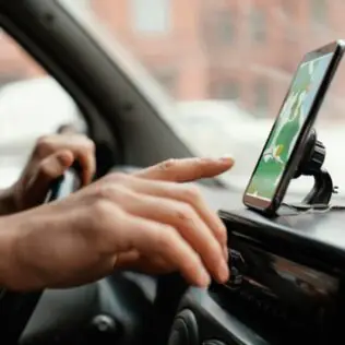 A Person Driving with a Map on Smartphone