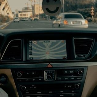 A person driving car during daytime