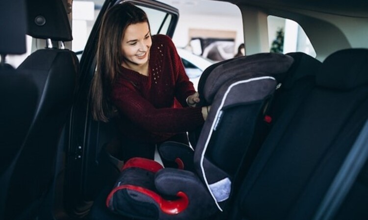Young mother and child in car Baby seat on chair Safety driving concept.