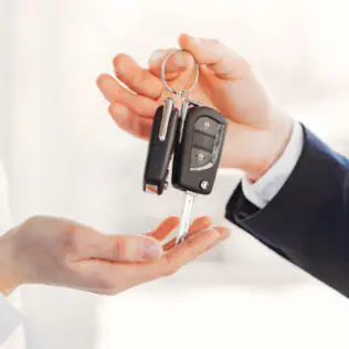 Keys being handed over from one person to another