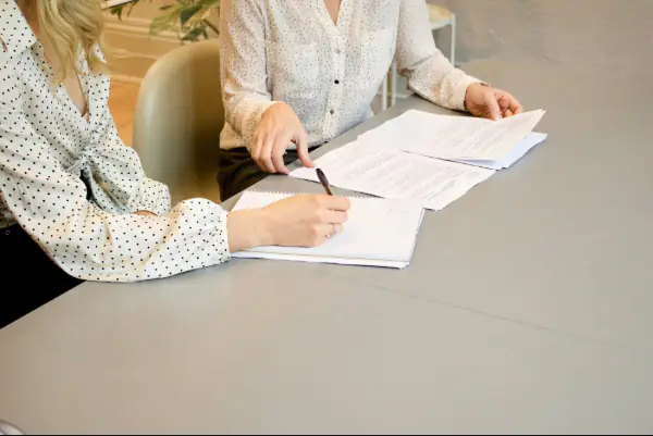 woman signing a documents