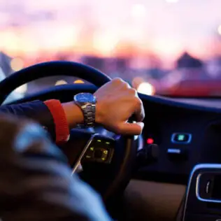Hand on steering wheel