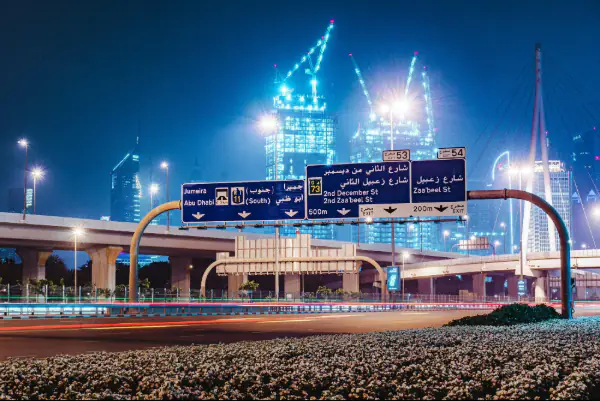blue and white street sign during night time