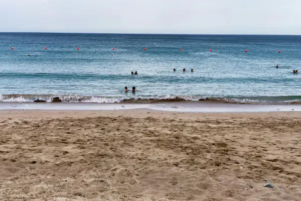people on Fujairah beach during daytime