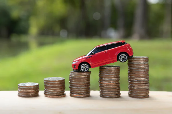 Toy car balancing over the increasing coin stack
