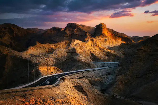 Concrete road near rocky mountain in Jebel Hafeet